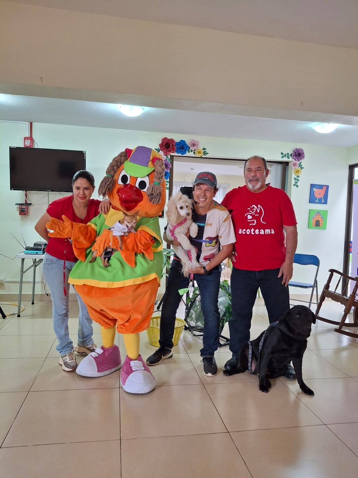 Voluntarios ACOTEAMA con perros en evento recreativo con payaso
